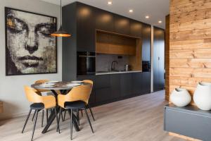 a kitchen and dining room with a table and chairs at Apartment Chamonix Eden D4 Hrabušice in Hrabušice