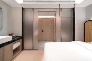 Voodi või voodid majutusasutuse Liuxiang Shangcui Hotel toas