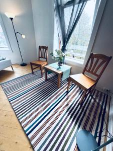 a living room with two chairs and a rug at RELAXED LIVING No 02 Historic Oslo in Oslo