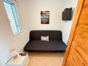 a bedroom with a black bed in a room at Miramar3, Costa Calma, traumhafter Meerblick, max 2 Pers in Costa Calma