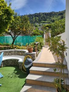 a garden with stairs and green grass at L'Agrumeto in Anacapri