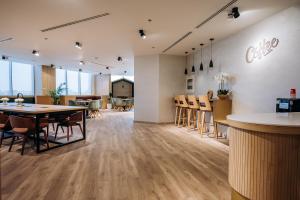 a room with a table and chairs and a kitchen at Fabulous Brand New 1BR in Ras al Khaimah