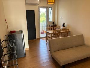 a living room with a couch and a table and chairs at 2 Bedroom 4 Pax Apartment Floor 8 Pelita Sky Garden in Nagoya