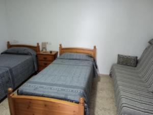 a bedroom with two twin beds and a dresser at Casa Lucas tres in Almáciga