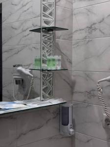 a bathroom with a white marble wall at JETISY COMPLEX in Taraz +28 photos