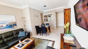 a living room with a couch and a table at Apartment with a beautiful view with a terrace in Roda golf & Beach resort in San Javier