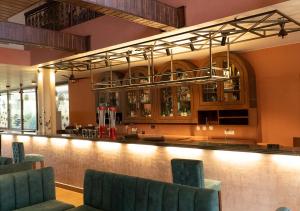 a bar in a restaurant with green chairs at Casa Peacock in Calangute
