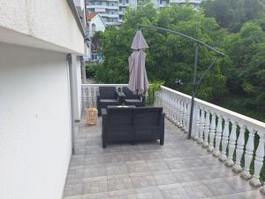 a balcony with two chairs and an umbrella at Vavic 1 in Španjola +2 photos