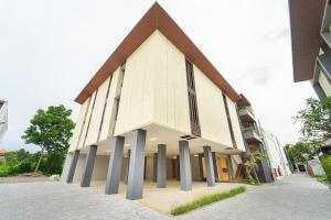 a large church with pillars in front of a building at Keenan Living Luxe Seturan in Seturan
