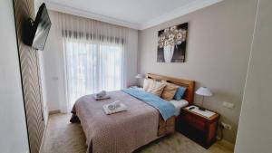 a bedroom with a bed with two towels on it at Apartment with a beautiful view with a terrace in Roda golf & Beach resort in San Javier +38 photos