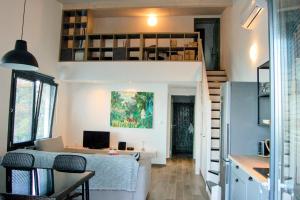 a small room with a table and a kitchen with a refrigerator at Olive Valley in Tyros