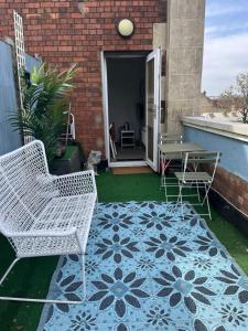 a patio with two chairs and a table on a patio at Modern apartment with terrace in Bristol