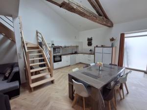 a kitchen and dining room with a table and chairs at Le Temps Suspendu in Trémentines