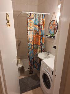 a bathroom with a toilet sink and a shower curtain at Igalo in Igalo