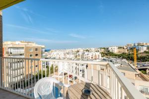 a balcony with a view of a city at Amazing apartment with pool in Malta in Is-Swieqi