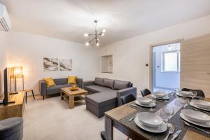 a living room with a couch and a table at Amazing apartment with pool in Malta in Is-Swieqi