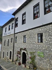 an old stone building with an archway in front of it at Sokak Boutique Hotel in Berat