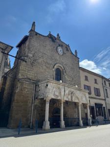 a building with a clock on the front of it at Chez OaNel in Andance