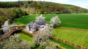 an aerial view of an old house in a field at Samieston Lodge, near Jedburgh in Whitton