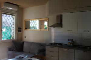 a living room with a couch and a kitchen at San Donato 40 in Bologna