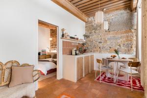 a kitchen with a table and a bed in a room at La Suite Saint Georges in Lyon