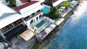 an aerial view of a building with a swimming pool at LA Beach Nusa Penida in Nusa Penida +8 photos