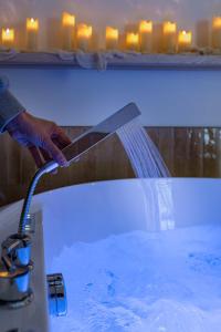 a person holding a knife in a bath tub at La Suite Saint Georges in Lyon