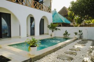a swimming pool in the backyard of a house at LA Beach Nusa Penida in Nusa Penida