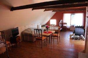 a living room with a table and chairs and a couch at Suur-Lossi Apartments in Haapsalu