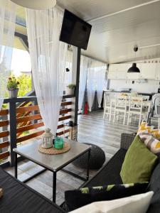 a living room with a couch and a table at La Veranda Sinemorets in Sinemorets
