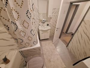 a white bathroom with a sink and a toilet at Vavic 2 in Topla