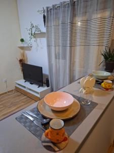 a kitchen with a counter with plates and bowls on it at Vavic 2 in Topla