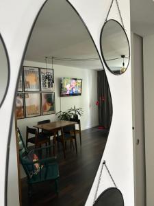 a dining room with a table and a mirror at Metro Trocka Apartment in Warsaw +34 photos