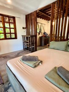 a bedroom with a large bed in a room at Hermit Bungalow #1 in Catangnan Gen Luna w STARLINK WIFI in General Luna