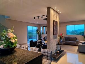 a living room with a table and chairs and a living room at Mol Residence in Esmeraldas