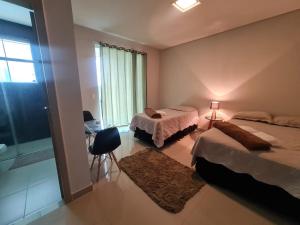 a hotel room with two beds and a window at Mol Residence in Esmeraldas