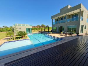 a house with a swimming pool in front of a house at Mol Residence in Esmeraldas +23 photos