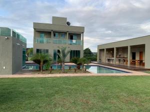 a large building with a swimming pool in front of it at Mol Residence in Esmeraldas
