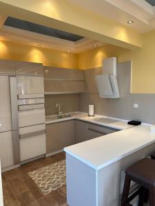 a kitchen with white cabinets and a white counter top at Villa DeMar - Coastal luxury in Ulcinj