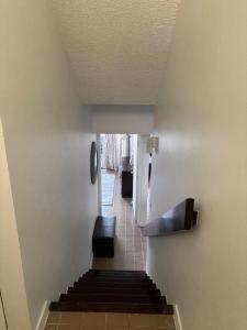 a hallway with a stairway with a stair case at The Beach Loft by Xio in Humacao +32 photos