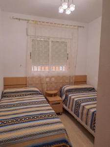 Giường trong phòng chung tại Bonito apartamento cerca del mar +25 ảnh