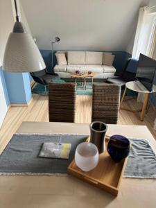 a living room with a couch and a table at Christiansand in Norddorf