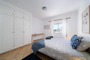 a bedroom with a bed with a teddy bear on it at Casa Rapp in Alvor +57 photos