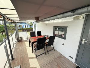 a covered patio with a table and chairs on it at Beach Resort Kamperland - 771 in Kamperland
