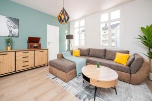 a living room with a couch and a table at Smart Home - Wuppertal - Perfect for 5 Guests! Netflix - Central - Smart TV - Free Parking Zone in Wuppertal