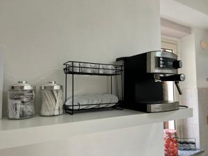 a microwave sitting on a shelf in a kitchen at Casa Vacanze Aurora in Coccorino