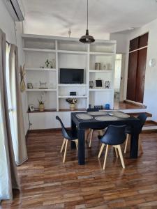 a dining room with a black table and chairs at Loft6 a solo 2 cuadras de la Costanera!!! in Corrientes +6 photos
