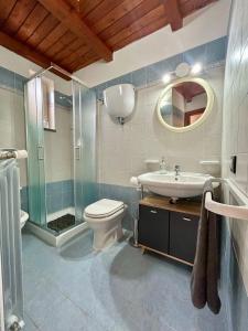 a bathroom with a toilet and a sink and a shower at Casa Vacanze Aurora in Coccorino +29 photos