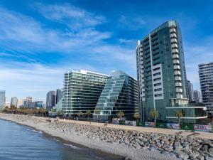 a group of tall buildings next to a beach at Boho apartment studio in Batumi