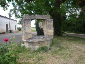 an old stoneolith sitting on the side of a road at Coup 2 Foudres in Saint-Jean-de-Blaignac